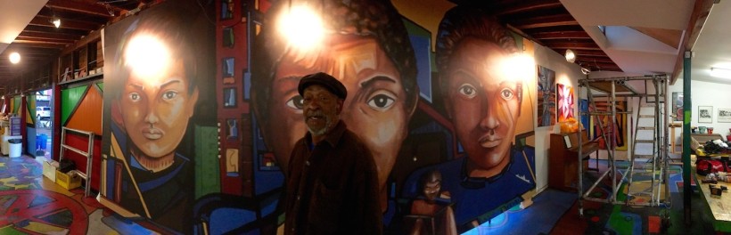 Roderick Sykes standing in front of the stretched print. 