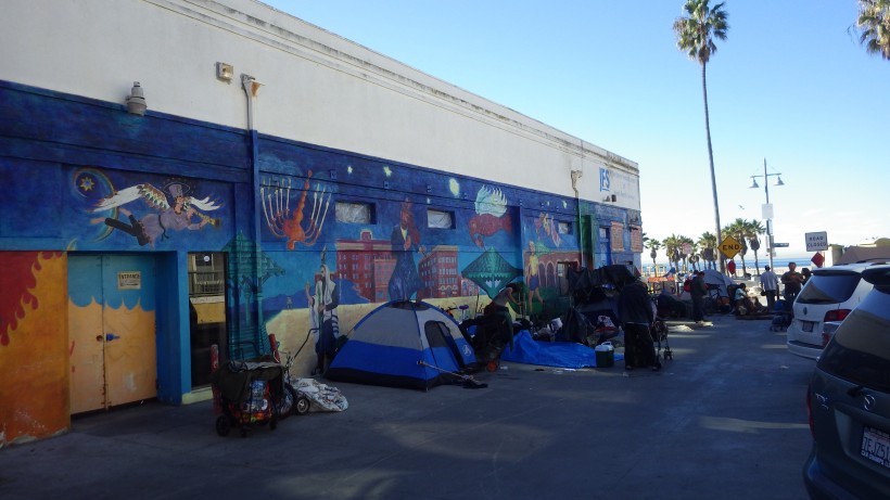 The homeless Venice Community gathers by the wall to make room for the weekly cleaning of Ocean Front Walk. 