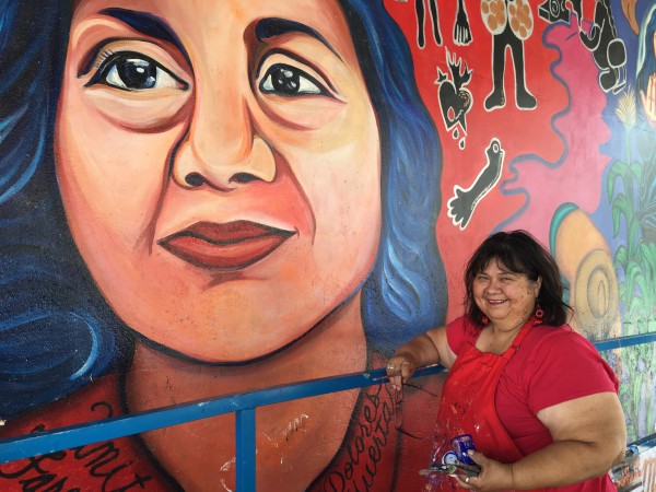 Yreina Cervantes working on the mural in 2016.